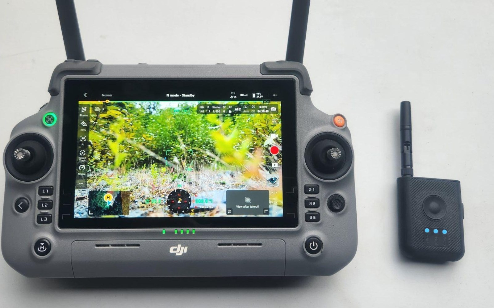A DroneTag Rider beside a DJI RC Plus 2 controller running the Eagle Eyes app