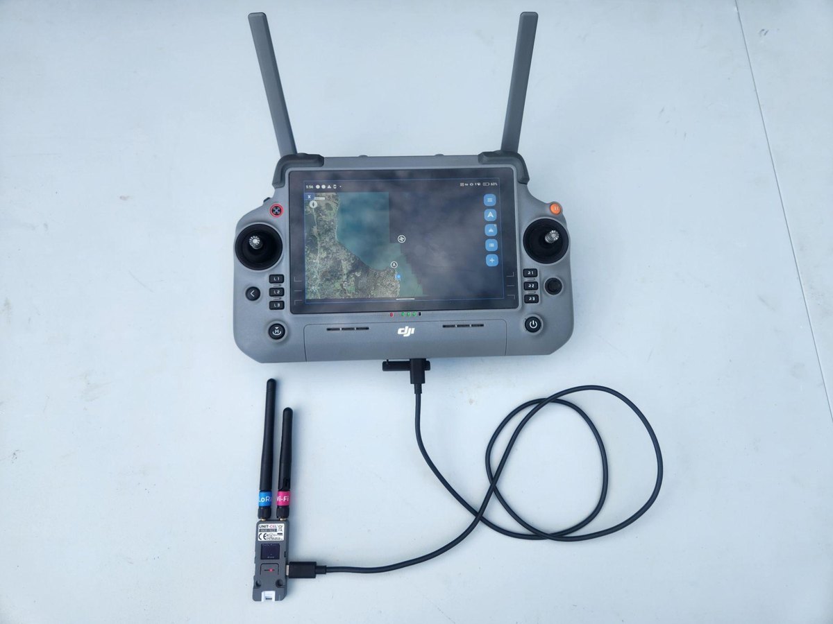 An M5Stack Unit C6L running Eagle Eyes RID firmware, plugged by USB into a DJI RC Plus controller